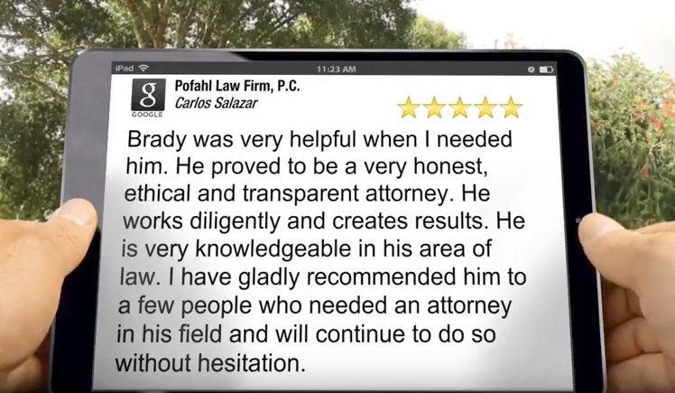 A person holding an iPad reading a five star review of Pofahl Law Firm, P.C. for a job well done on another car accident case.
